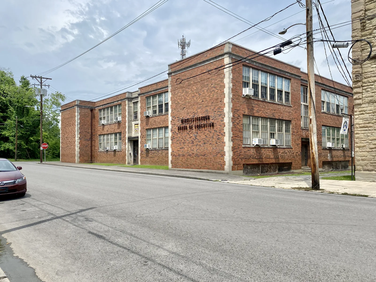 Built in the late 1920s, this Classical Revival-style building was constructed to serve as Middlesboro Junior High School, supplementing the nearby Central School and Middlesboro High School, built in 1910 and 1920, respectively.  The building features a red brick exterior, stone trim, quoins, six-over-six double-hung windows, a stone surround at the main entrance bay at the center of the 20th Street facade, quoins at the corners of the building, and a rear gymnasium wing.  The building is a con