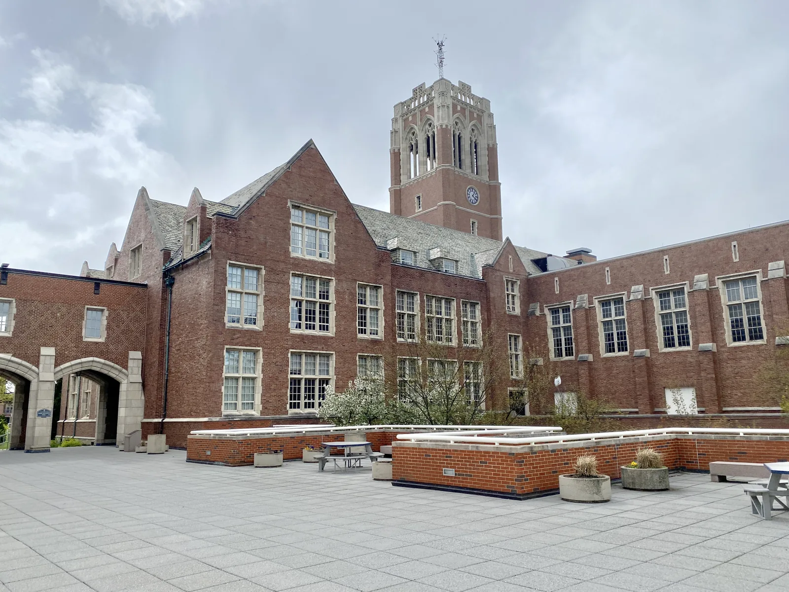 Built in 1931-1935, this Collegiate Gothic Revival-style building was designed by Philip L. Small, Inc. to serve as the centerpiece of a new campus built for the Jesuit-affiliated John Carroll University, which was moving from an urban campus in Ohio City to suburban University Heights.  The building features a hipped slate roof with front-gabled end wings, red brick cladding, an orthogonal central tower, known as Grasselli Tower, with corner octagonal buttresses, an open belfry featuring gothic