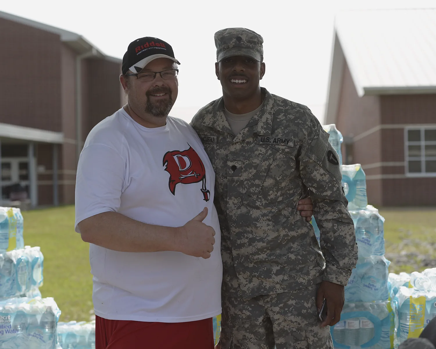 Lance Dale, Deweyville Independent School District's athletic director, and Spc. Idell McCarthur, a 72nd Infantry Brigade Combat Team soldier, Texas Army National Guard, forged a friendship during Southest Texas flood response March 15, 2016. Texas Guardsmen supported flood response operations in Orange, Jasper and Newton counties rescuing more than 400 people and conducting shelter operations for hundreds of evacuated Texans. (U.S. Air National Guard photo by 1st Lt. Alicia Lacy/Released)
Unit: