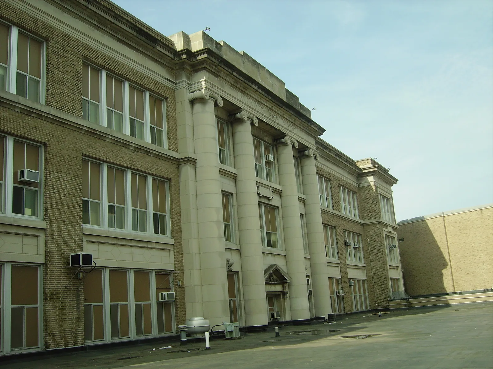 Closeup view of old building, Lakewood High School, Lakewood, Ohio. Roof of cafeteria in foreground, a gymnasium to the right, (out of picture) blocks view of building from the street.
