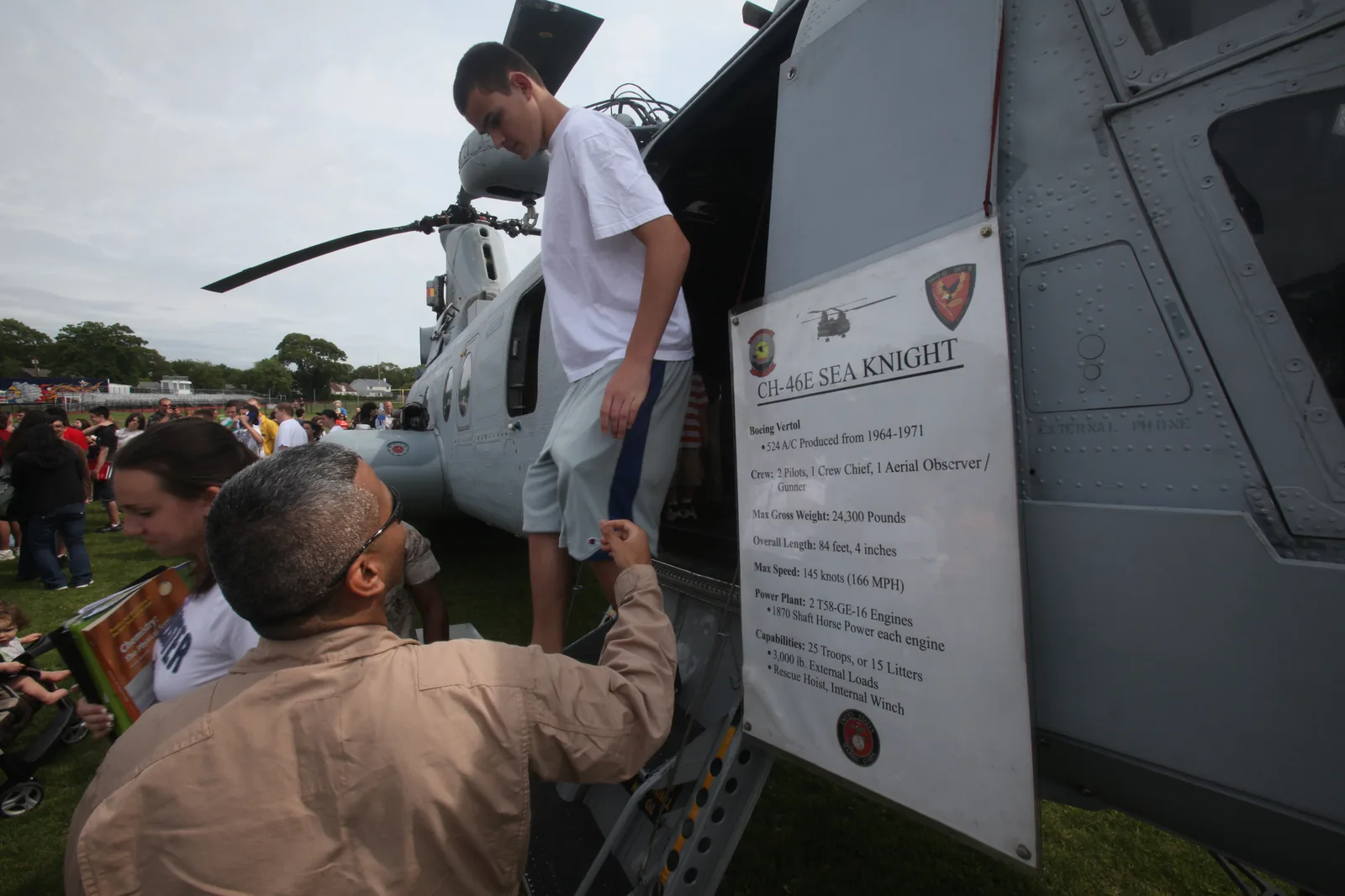 Students tour a CH-46 Sea Knight helicopter at Massapequa High School during a helicopter raid demonstration performed by the Marines of Special Purpose Marine Air Ground Task Force New York May 29. More than 3,000 Marines, Sailors and Coast Guardsmen will be in the area participating in community outreach events and equipment demonstrations. This is the 26th year New York City has hosted the sea services for Fleet Week.